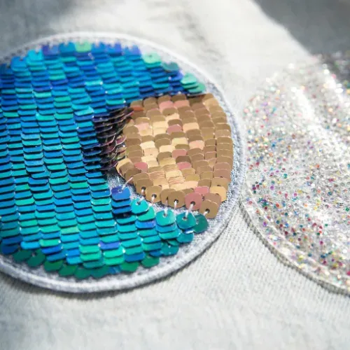 Close up of a sequin patch with shimmering flip sequins and glitter texture