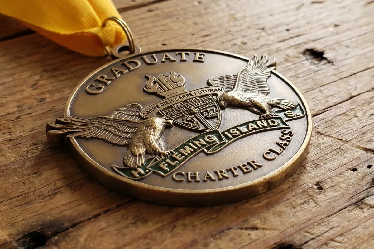 Die struck custom award medal with crisp raised relief and polished metal finish