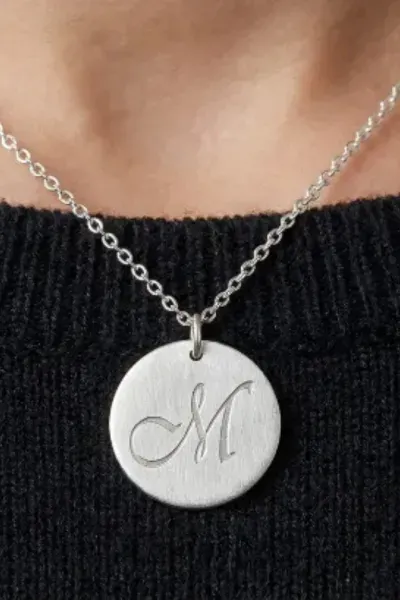 custom silver pendant around the persons neck