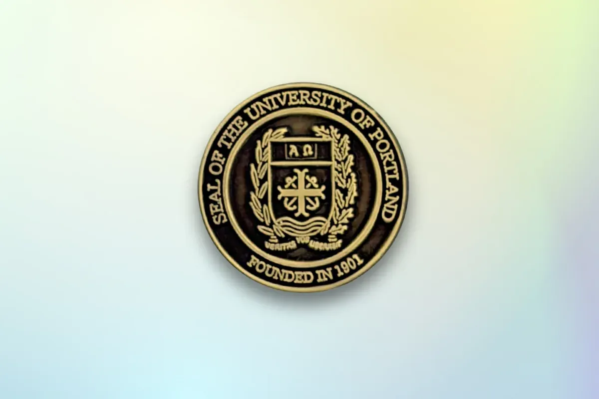 Custom die-struck university lapel pin in antique gold with institutional seal and laurel wreath