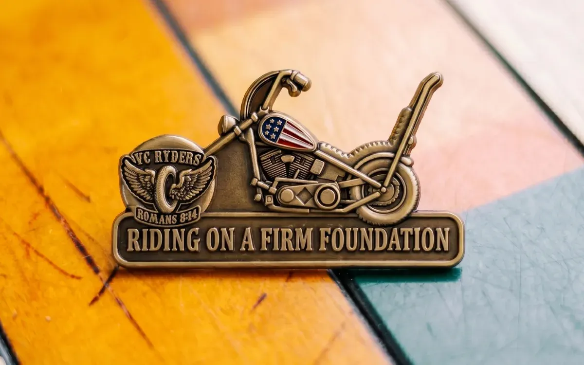 Custom die-struck motorcycle club lapel pin in antique bronze finish