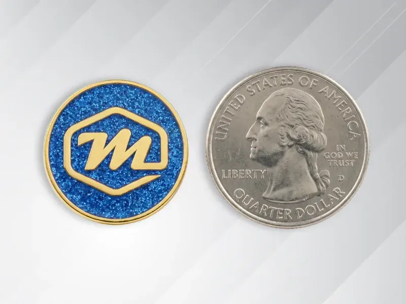 Standard 1 to 1.25 inch custom lapel pin shown next to a quarter for size reference