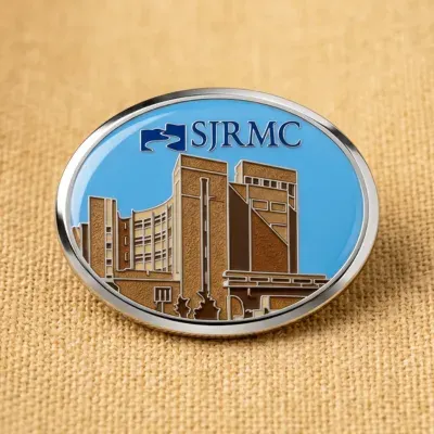 Custom printed oval lapel pin with full-color medical center building artwork under epoxy dome