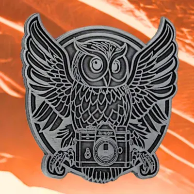 Custom antique silver lapel pin featuring an owl perched on a vintage camera