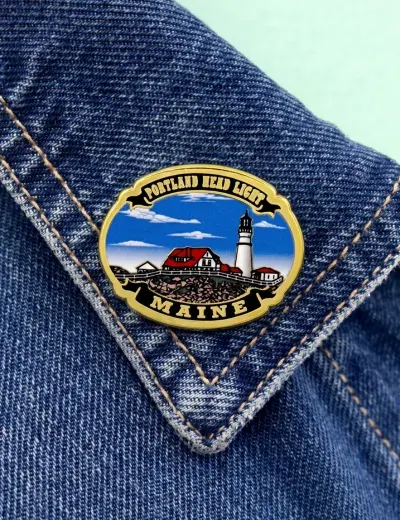 Custom printed enamel lapel pin with full-color lighthouse artwork under epoxy dome