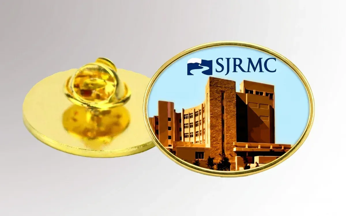 Custom printed lapel pin with full-color medical center artwork under epoxy dome