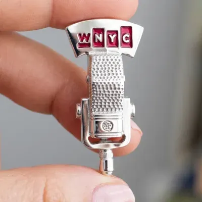 Custom 3D cast lapel pin shaped like a vintage radio microphone for broadcast branding