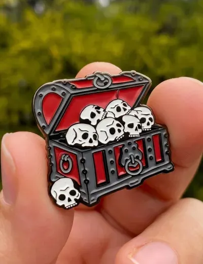 Custom soft enamel lapel pin with black nickel plating and red enamel skull treasure chest design