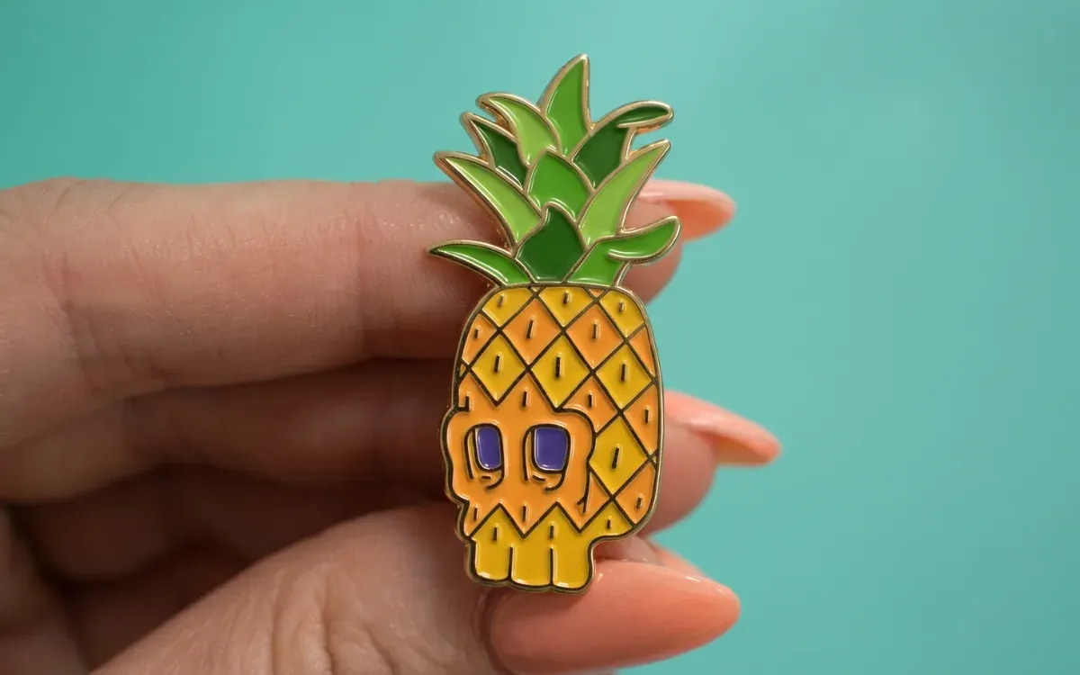 Custom soft enamel lapel pin with raised metal lines in yellow pineapple shape