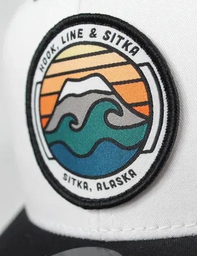 Custom woven Tooth Line and Sitka wave-scene patch on a hat