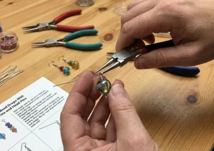 adding beads to a bag charm