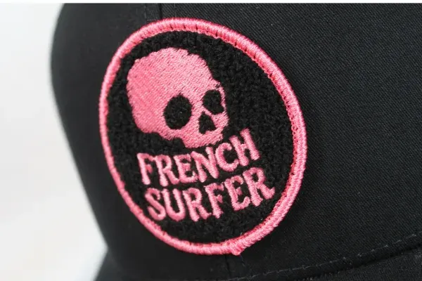 Custom chenille French Surfer skull patch in pink on a black hat