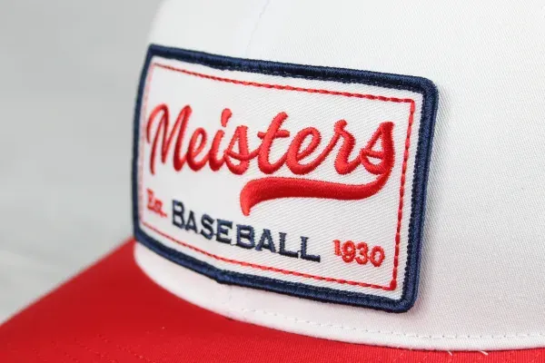 Custom embroidered Meisters Baseball patch on a red and white trucker hat