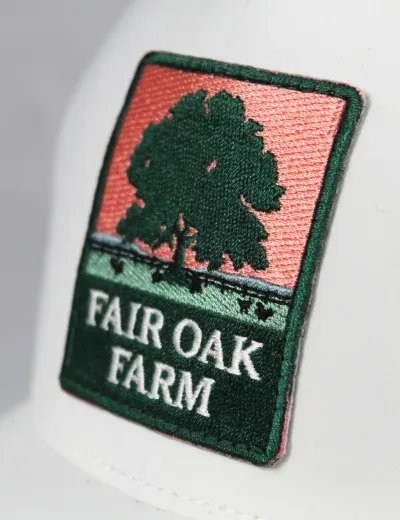 Custom embroidered Fair Oak Farm tree-logo patch on a hat
