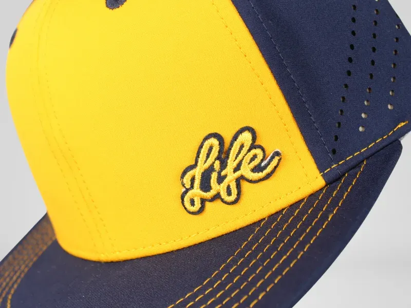 Custom yellow and blue embroidered patch on an flat bill Richardson hat