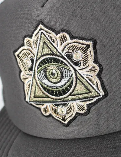 Custom embroidered all-seeing-eye patch on a gray trucker hat