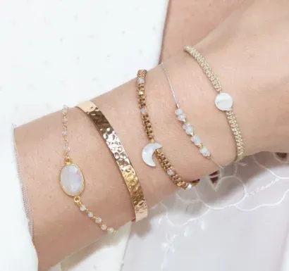 group of charm bracelets in gold and silver