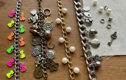 group of charm bracelets on table