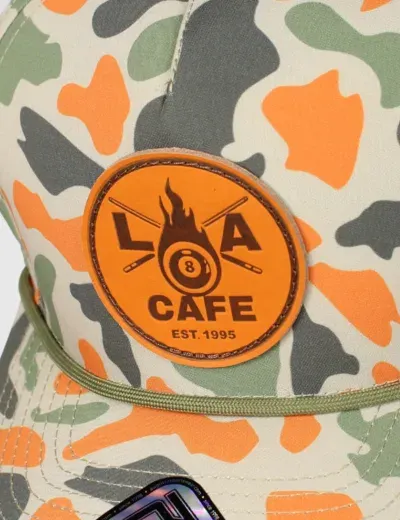 Custom embroidered LA Cafe circle patch on a camo rope hat