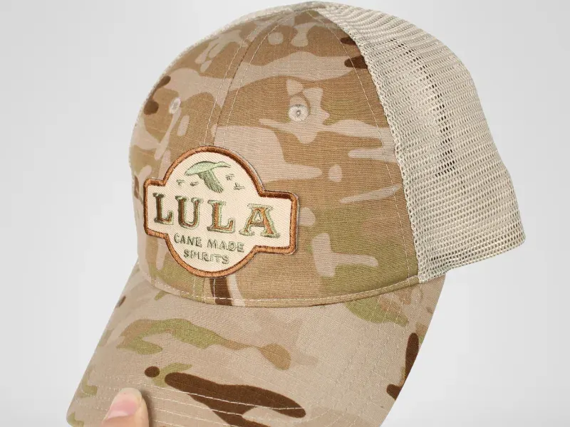 Custom embroidery patch on tan camo trucker hat