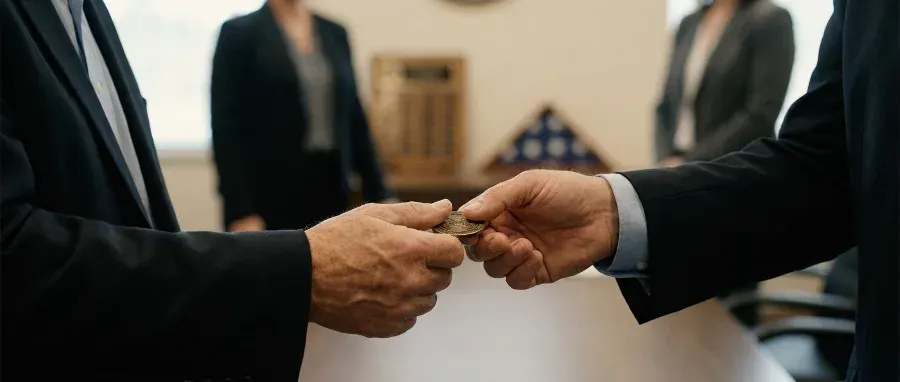 Challenge coin being presented to a retiree during a retirement ceremony