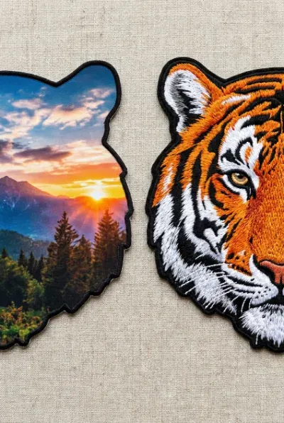 Side by side comparison of a sublimated patch with smooth color gradients and an embroidered patch with raised thread texture