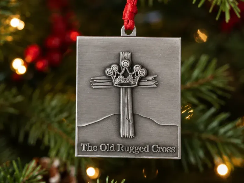 pewter ornament with antique finish and dimensional relief of a Cross