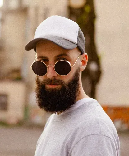 guy with cool glasses wearing a trucker hat